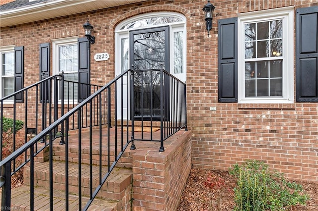 property entrance featuring brick siding