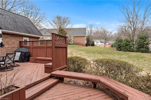 wooden deck featuring a yard and grilling area