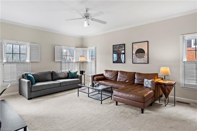 living room with carpet floors, ornamental molding, visible vents, and baseboards