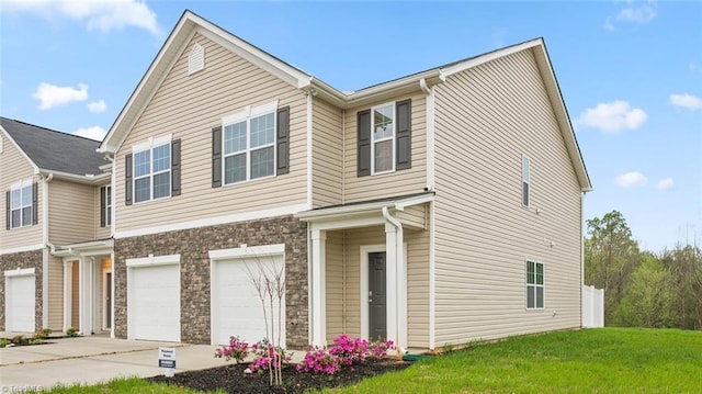 view of front of house with a garage and a front lawn