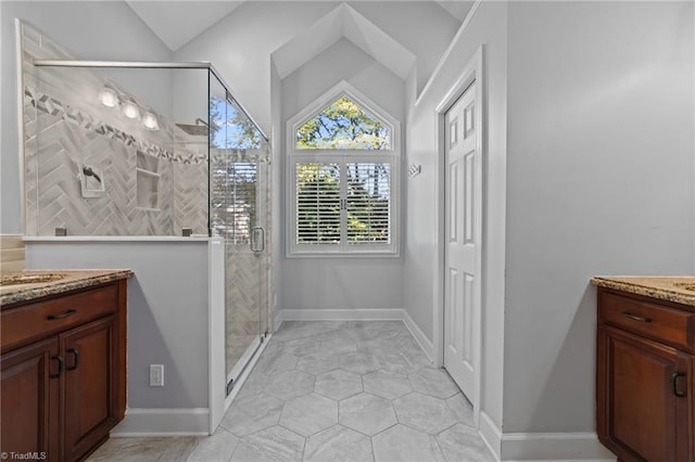 bathroom with tile patterned flooring, a shower with door, and vanity