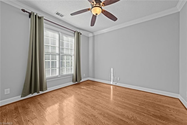 spare room with ornamental molding, ceiling fan, light hardwood / wood-style floors, and a textured ceiling