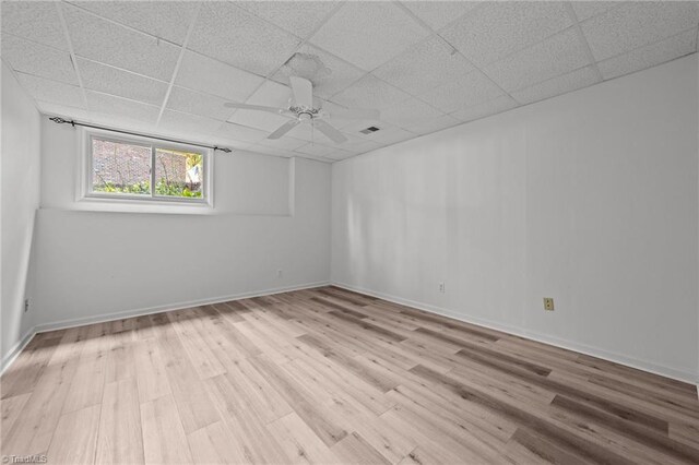 spare room featuring a drop ceiling, ceiling fan, and light hardwood / wood-style floors