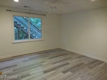 unfurnished room with light wood-type flooring