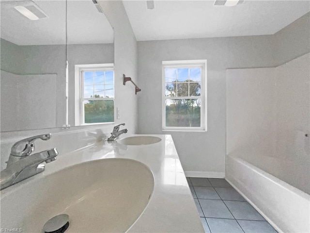 bathroom featuring tile patterned floors, vanity, and a wealth of natural light