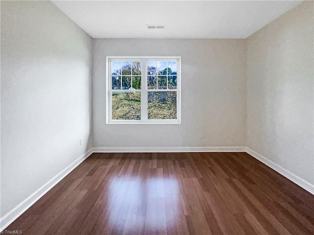 spare room with dark wood-type flooring