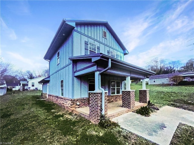 exterior space featuring covered porch and a front lawn