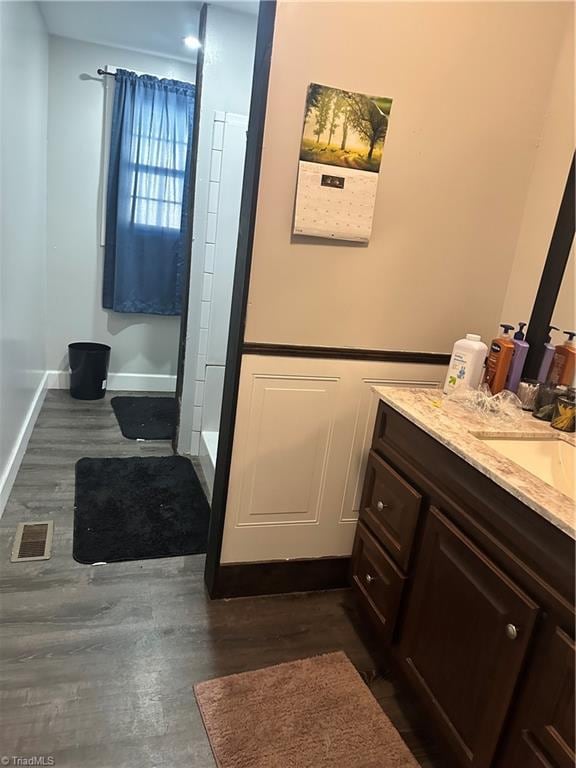 bathroom with vanity and wood-type flooring