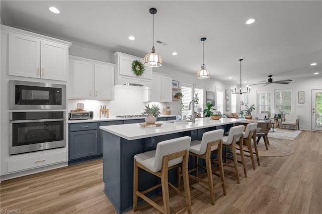 5120 Whaitley Ln, Greensboro, NC 27407 - kitchen featuring stainless steel appliances, recessed lighting, light countertops, a center island with sink, and open floor plan
