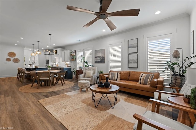 5120 Whaitley Ln, Greensboro, NC 27407 - living area with wood finished floors, recessed lighting, a chandelier, ceiling fan, and ornamental molding