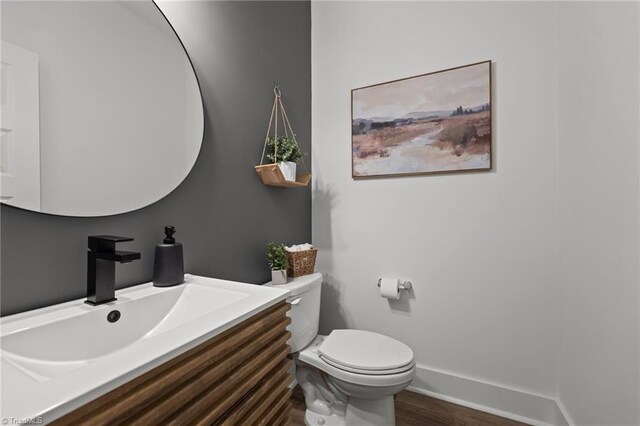 5120 Whaitley Ln, Greensboro, NC 27407 - bathroom with toilet, vanity, and wood finished floors