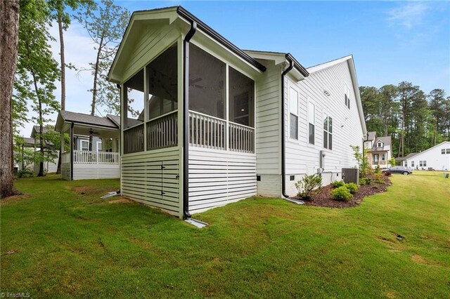 5120 Whaitley Ln, Greensboro, NC 27407 - view of side of property with central AC unit, a yard, crawl space, a sunroom, and a ceiling fan