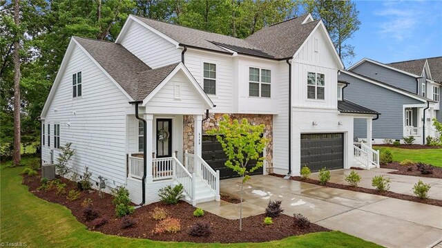 5120 Whaitley Ln, Greensboro, NC 27407 - modern farmhouse style home with driveway, a garage, roof with shingles, board and batten siding, and central AC unit