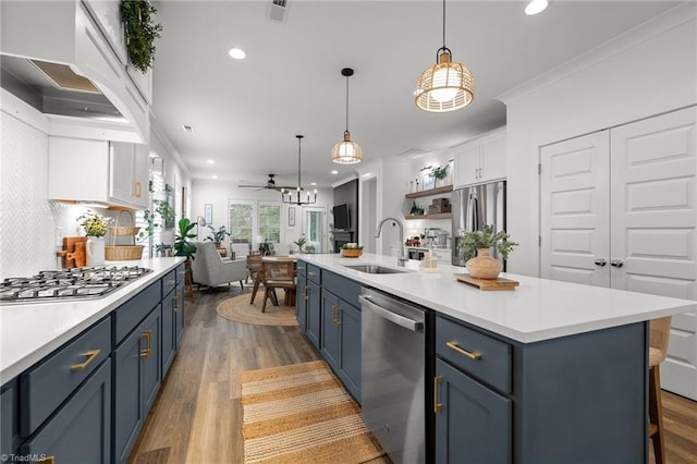 5120 Whaitley Ln, Greensboro, NC 27407 - kitchen featuring stainless steel appliances, blue cabinets, a sink, recessed lighting, and light countertops