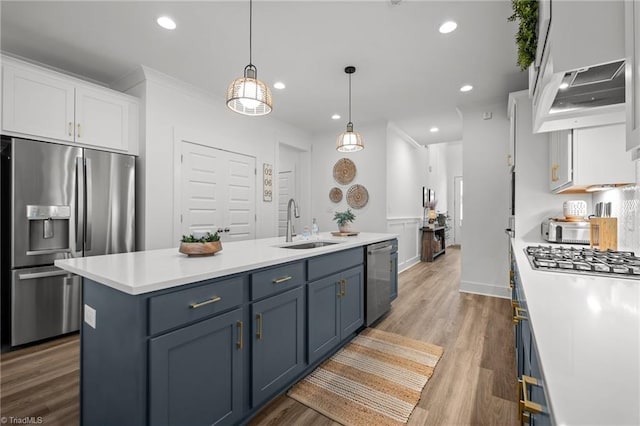 5120 Whaitley Ln, Greensboro, NC 27407 - kitchen with appliances with stainless steel finishes, white cabinets, under cabinet range hood, a sink, and light countertops