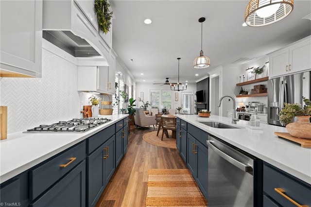 5120 Whaitley Ln, Greensboro, NC 27407 - kitchen featuring appliances with stainless steel finishes, a sink, blue cabinetry, white cabinetry, and recessed lighting