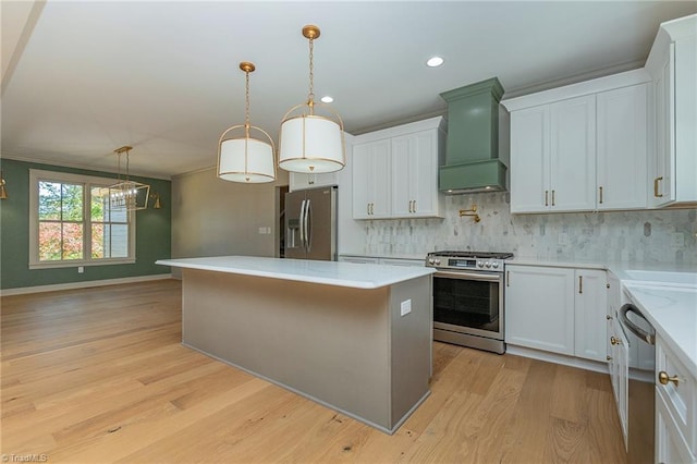 kitchen with custom range hood, stainless steel appliances, white cabinetry, and a kitchen island