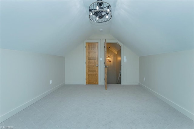 additional living space with vaulted ceiling and light carpet