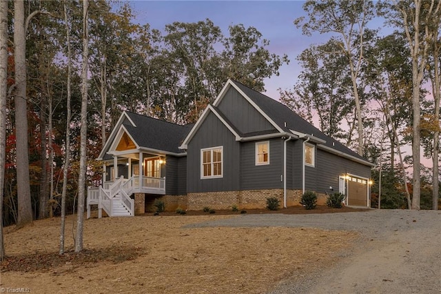 view of front of house featuring a garage and a porch