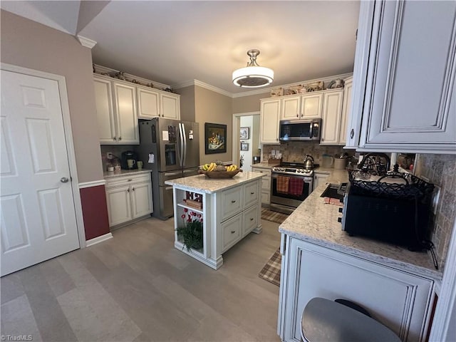 5244 Old Plantation Cir, Winston-Salem, NC 27104 - kitchen featuring appliances with stainless steel finishes, crown molding, tasteful backsplash, light stone counters, and a kitchen island