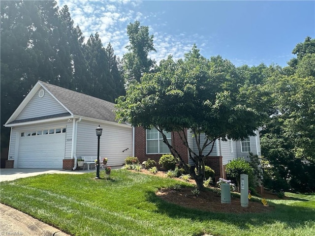 5244 Old Plantation Cir, Winston-Salem, NC 27104 - obstructed view of property with an attached garage, a front lawn, driveway, and brick siding