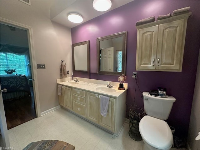 5244 Old Plantation Cir, Winston-Salem, NC 27104 - ensuite bathroom with double vanity, baseboards, and toilet