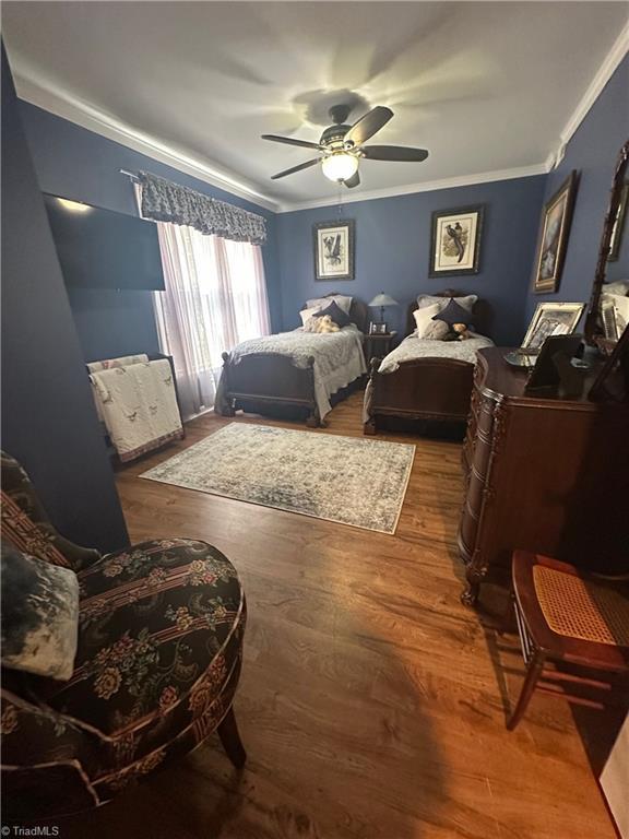 5244 Old Plantation Cir, Winston-Salem, NC 27104 - bedroom featuring ornamental molding, wood finished floors, and a ceiling fan