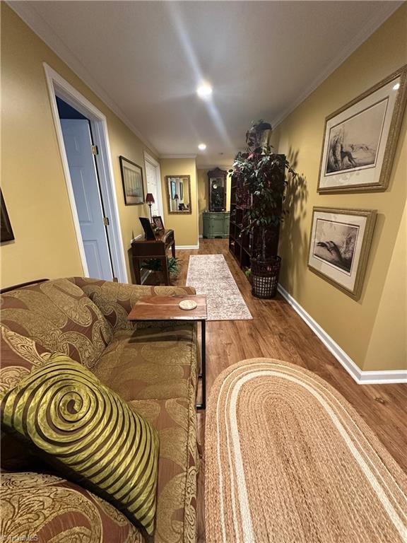 5244 Old Plantation Cir, Winston-Salem, NC 27104 - living room featuring wood finished floors, baseboards, crown molding, and recessed lighting