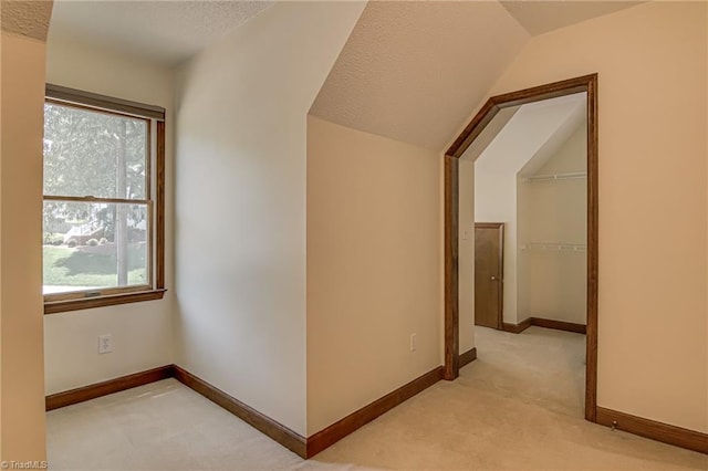 417 Avery Ave, High Point, NC 27265 - hallway with light colored carpet, lofted ceiling, and a textured ceiling