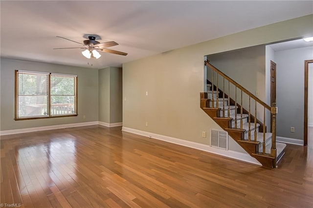 417 Avery Ave, High Point, NC 27265 - unfurnished living room with wood finished floors, ceiling fan, and stairs