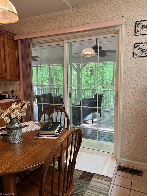 209 Cedar Ln, North Wilkesboro, NC 28659 - tiled dining room with wallpapered walls, healthy amount of natural light, crown molding, a ceiling fan, and baseboards
