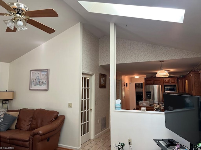 209 Cedar Ln, North Wilkesboro, NC 28659 - living area with a skylight, light tile patterned floors, ceiling fan, and high vaulted ceiling
