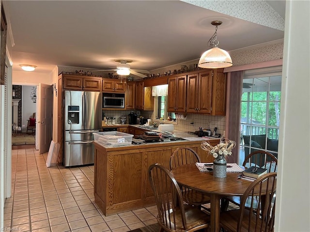 209 Cedar Ln, North Wilkesboro, NC 28659 - kitchen with appliances with stainless steel finishes, a peninsula, light tile patterned flooring, decorative backsplash, and ornamental molding
