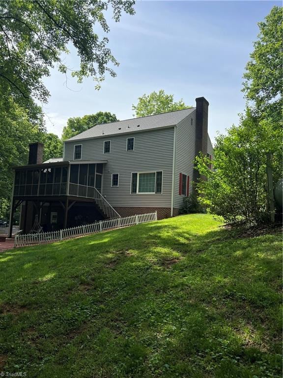 209 Cedar Ln, North Wilkesboro, NC 28659 - back of property with a chimney, a sunroom, and a yard