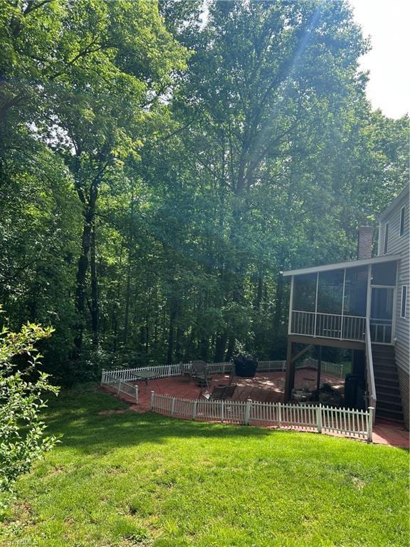 209 Cedar Ln, North Wilkesboro, NC 28659 - view of green lawn featuring a sunroom, stairway, a patio area, and a wooden deck