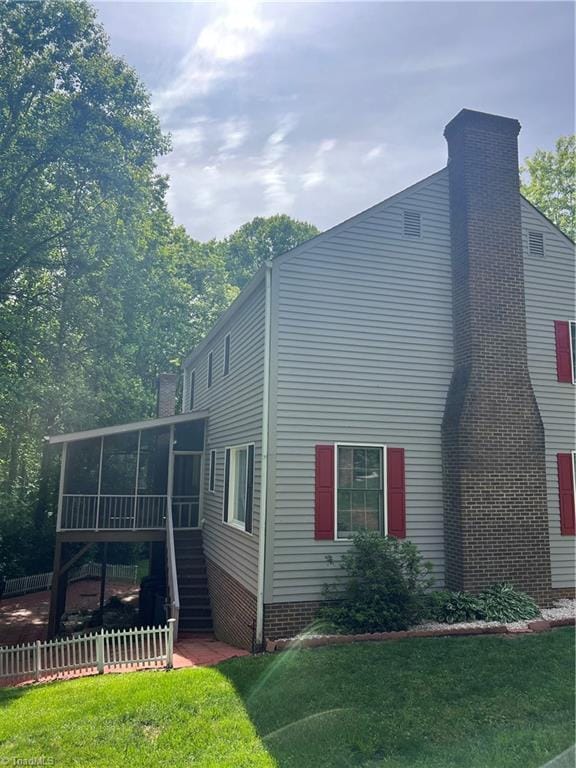 209 Cedar Ln, North Wilkesboro, NC 28659 - view of property exterior with a sunroom, stairway, and a chimney