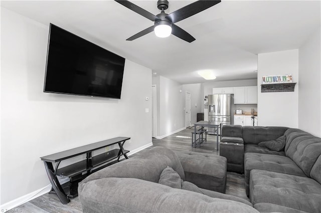 living room featuring hardwood / wood-style floors and ceiling fan