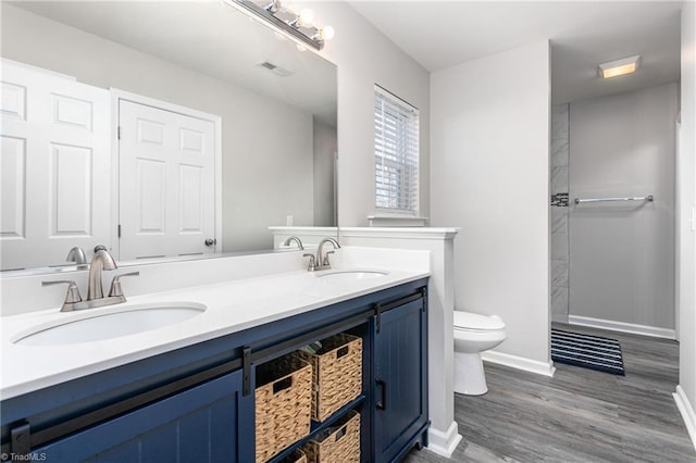 bathroom with vanity, hardwood / wood-style flooring, and toilet