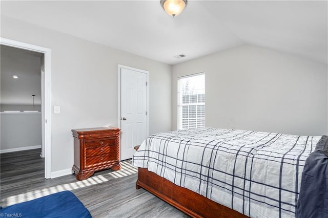 bedroom featuring vaulted ceiling and dark hardwood / wood-style floors