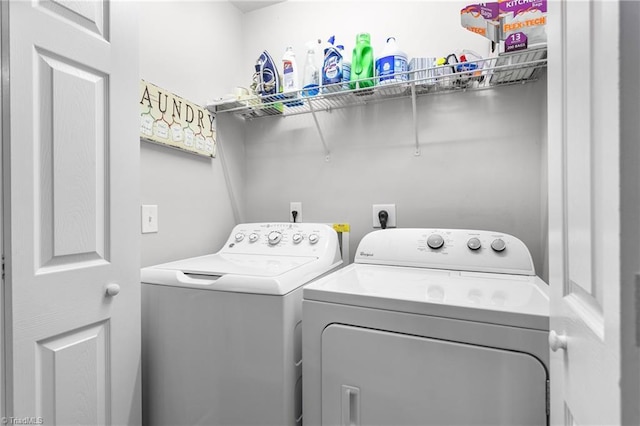 clothes washing area with washer and clothes dryer