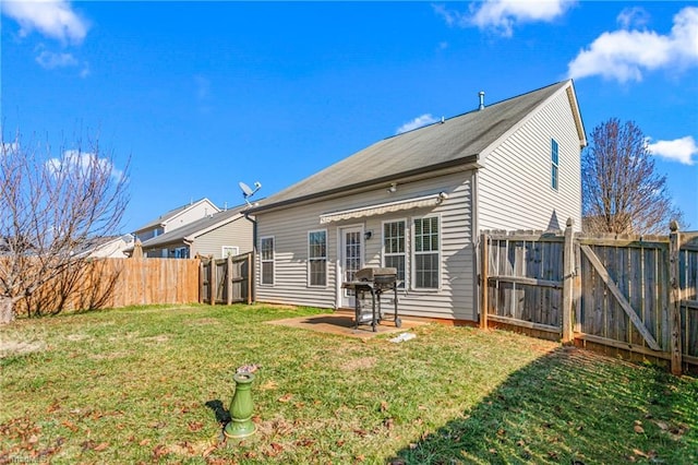 rear view of property with a lawn and a patio