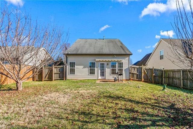 rear view of property with a lawn