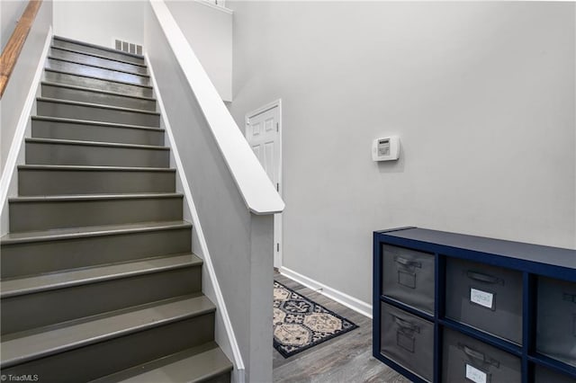 staircase with hardwood / wood-style flooring