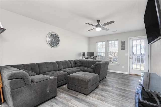 living room featuring ceiling fan and hardwood / wood-style flooring