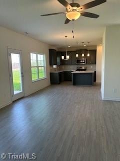 238 Plains Dr Lot # 313, Burlington, NC 27217 - kitchen featuring baseboards, stainless steel microwave, open floor plan, light countertops, and light wood-type flooring