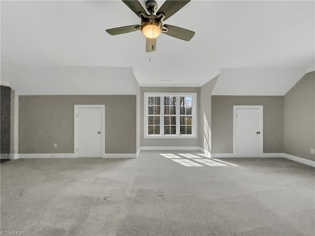 interior space featuring baseboards, carpet, and vaulted ceiling