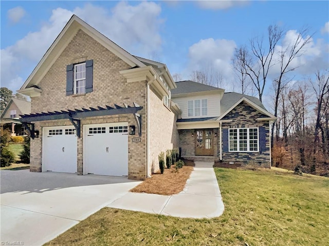 traditional-style home featuring brick siding, a garage, a front lawn, and driveway