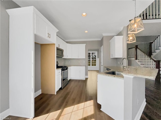 kitchen with light stone counters, a peninsula, dark wood-style flooring, a sink, and stainless steel appliances