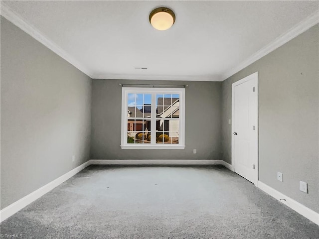 unfurnished room with visible vents, baseboards, and ornamental molding