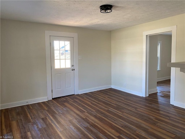 interior space featuring dark wood-type flooring and a textured ceiling